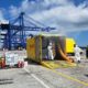 Operarios de TransPiedra con trajes de protección química junto a un contenedor en la Terminal TTI de Algeciras